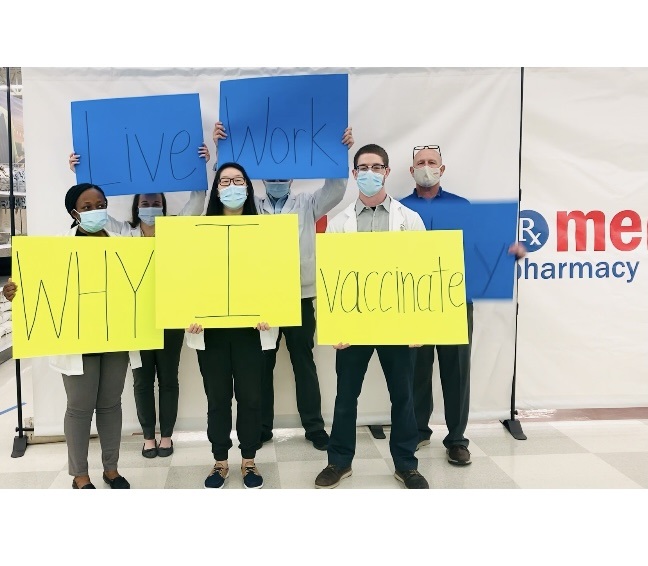 The Klaserners volunteering at a vaccine clinic. Ally second from left, Adam and John at right.