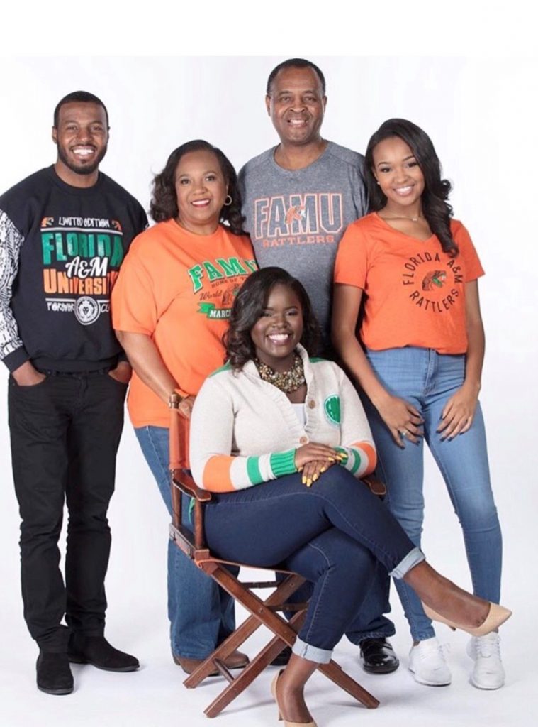 Vivian Bradley Johnson, PharmD, MBA, FASHP with her family. Everyone in the family is wearing shirts from Florida A&M University, a HBCU, where Johnson completed her undergraduate pharmacy degree.