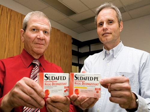 Leslie Hendeles (left) and Randy Hatton compare the packaging of Sudafed (with pseudoephedrine) and Sudafed-PE