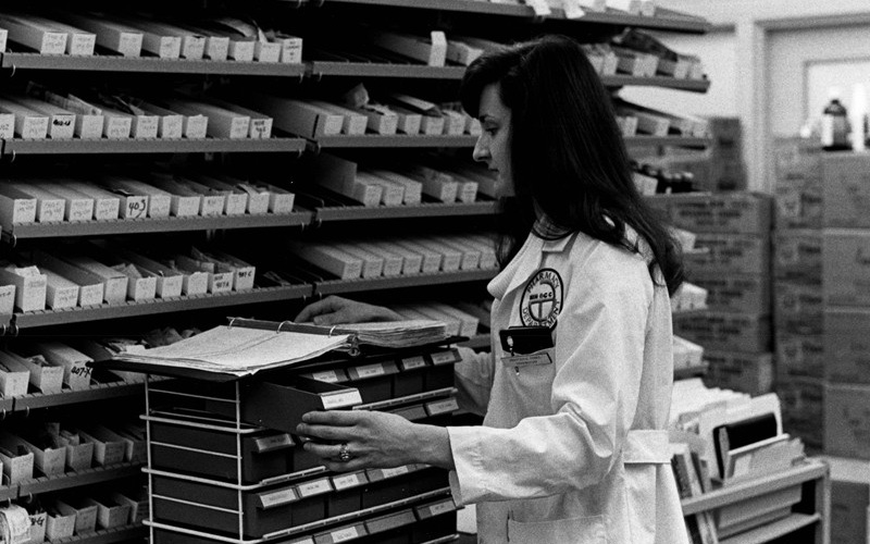 NIH pharmacist Anastasia E. Perez places unit doses in individual patient boxes (1978)