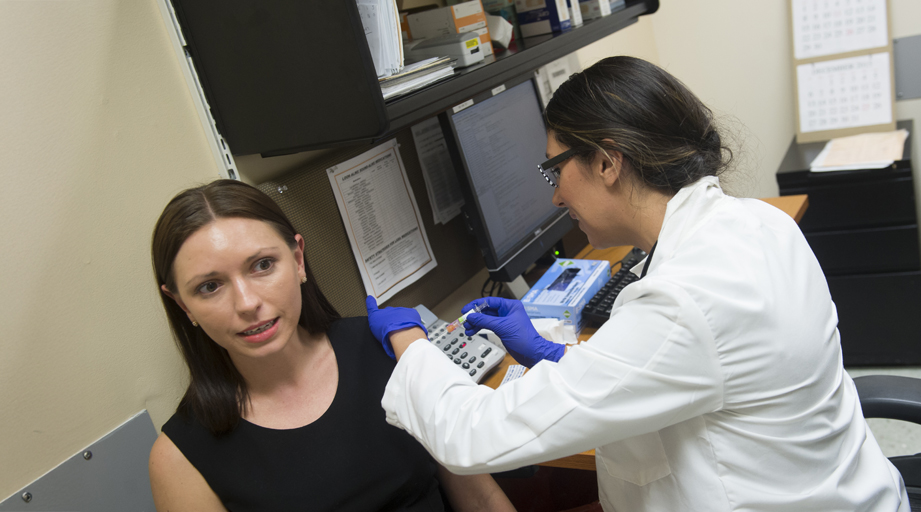 a pharmacist administering a vaccination to a patient