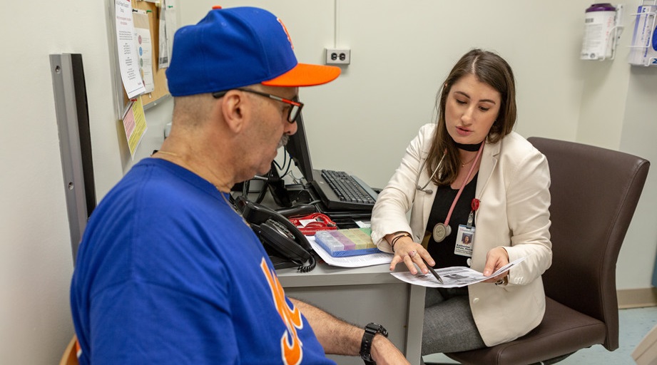 a female pharmacist talking to a male patient