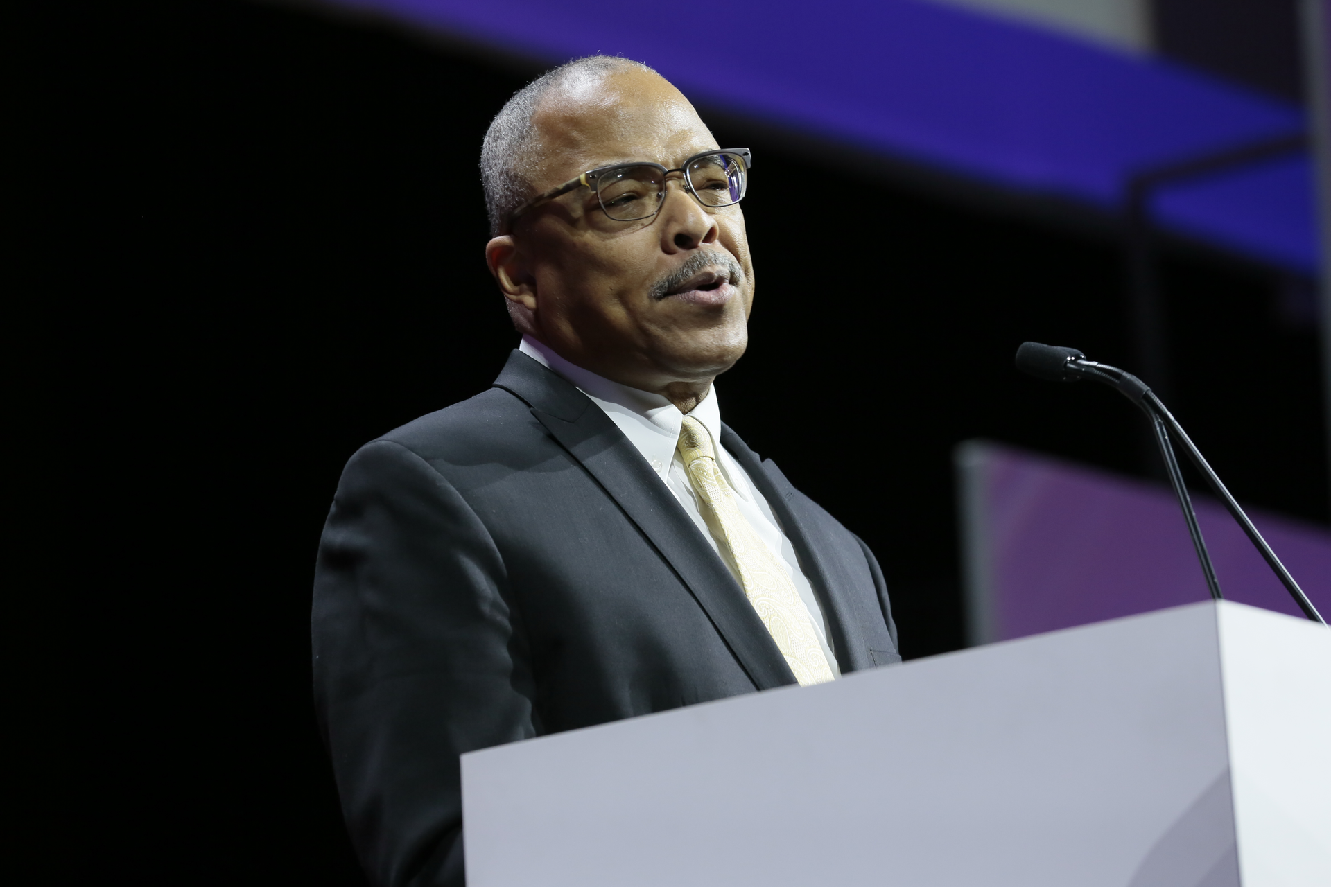 Paul C. Walker speaking at podium