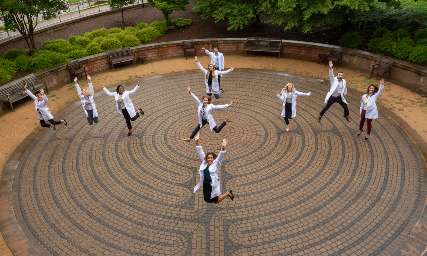 pharmacists happily jumping for joy on top of a wellness walking circle path
