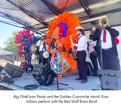 Big Chief Juan Pardo and the Golden Comanche Mardi Gras Indians perform with the Red Wolf Brass Band