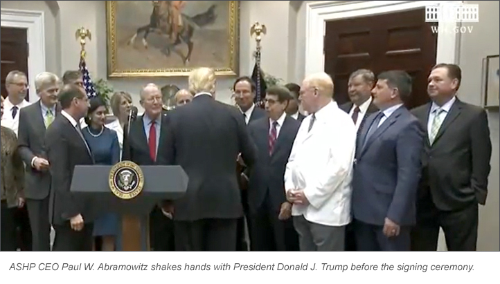 ASHP CEO Paul W. Abramowitz shakes hands with President Donald J. Trump before the signing ceremony.