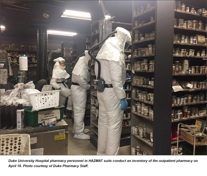 Duke University Hospital pharmacy personnel in HAZMAT suits conduct an inventory of the outpatient pharmacy on  April 18. Photo courtesy of Duke Pharmacy Staff.
